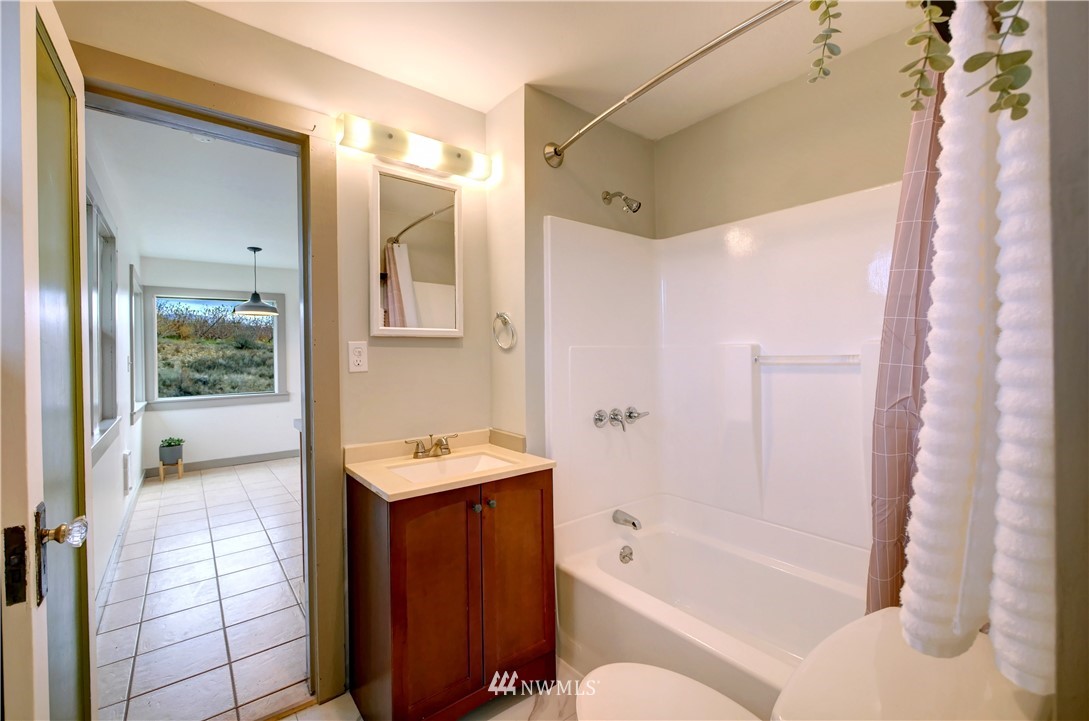 28 Fiker Road Omak, WA 98841 - Photo 22 of 39 a bathroom with a tub sink toilet and shower