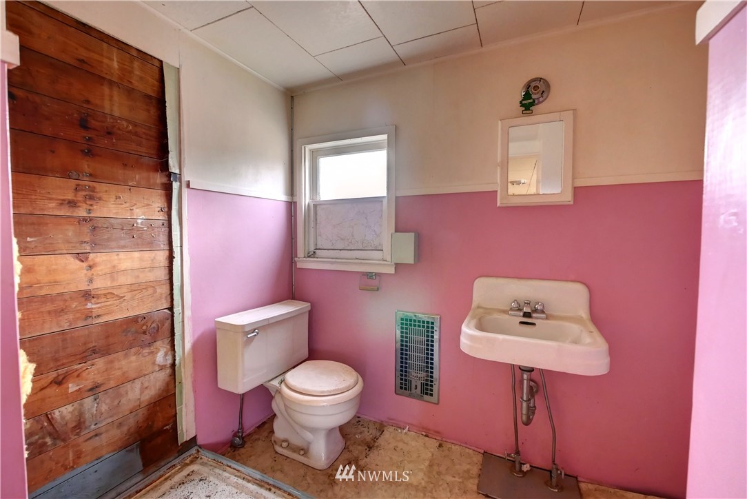 28 Fiker Road Omak, WA 98841 - Photo 26 of 39 a white toilet sitting next to a bathroom sink