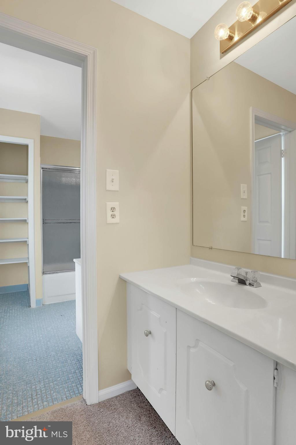 9160 Rockefeller Lane Springfield, VA 22153 - Photo 16 of 27 a bathroom with a sink and a mirror