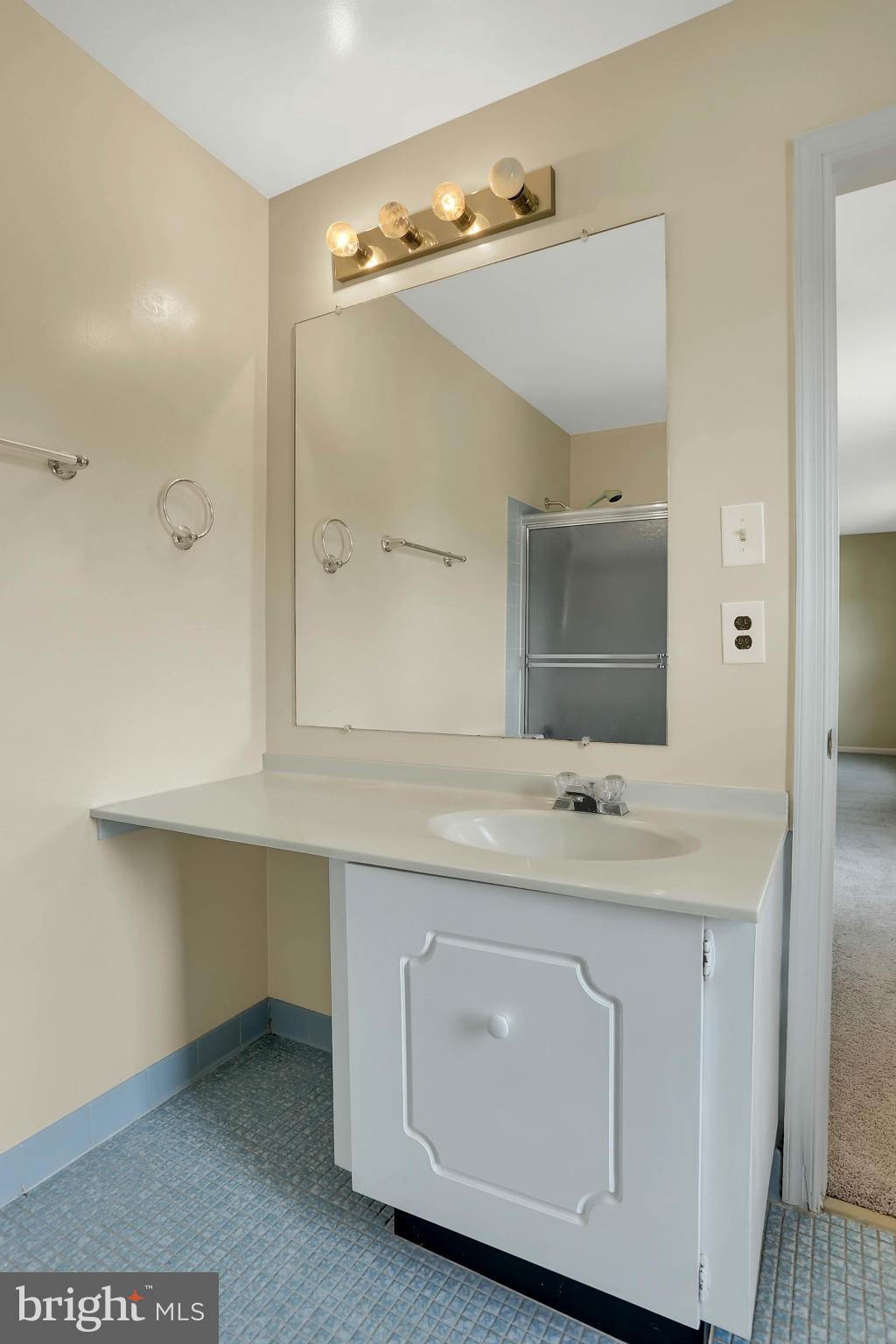 9160 Rockefeller Lane Springfield, VA 22153 - Photo 17 of 27 a spacious bathroom with a double vanity sink and mirror