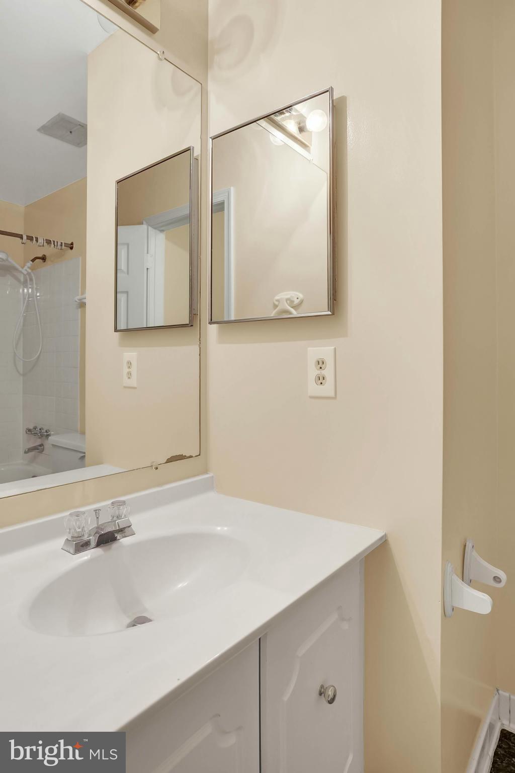 9160 Rockefeller Lane Springfield, VA 22153 - Photo 21 of 27 a bathroom with a sink and a mirror