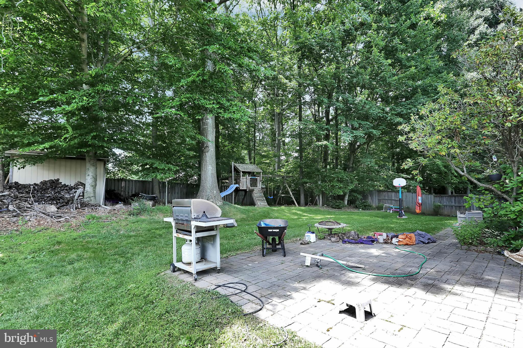 9160 Rockefeller Lane Springfield, VA 22153 - Photo 25 of 27 a view of a chair and table in backyard of the house