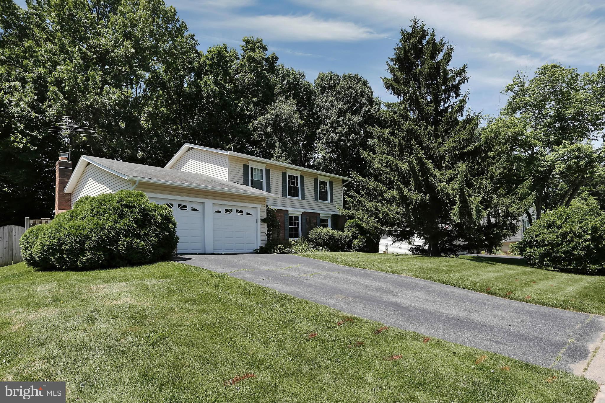 9160 Rockefeller Lane Springfield, VA 22153 - Photo 6 of 27 a front view of a house with a garden and yard