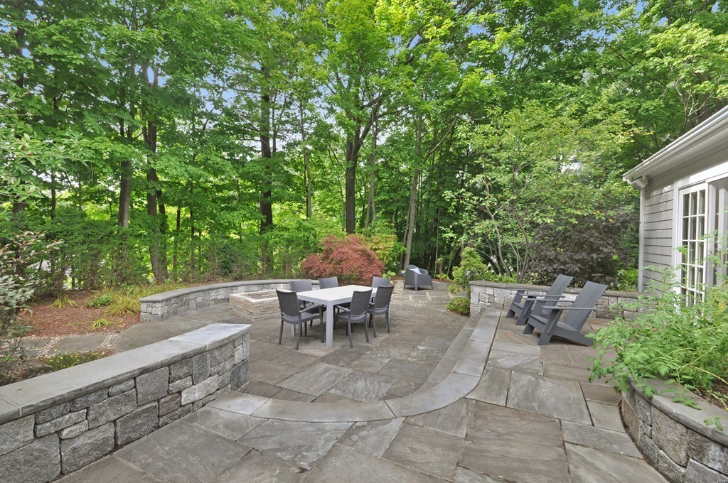 32 Martin Road Concord, MA 01742 - Photo 14 of 17 a view of a patio with table and chairs potted plants with wooden fence