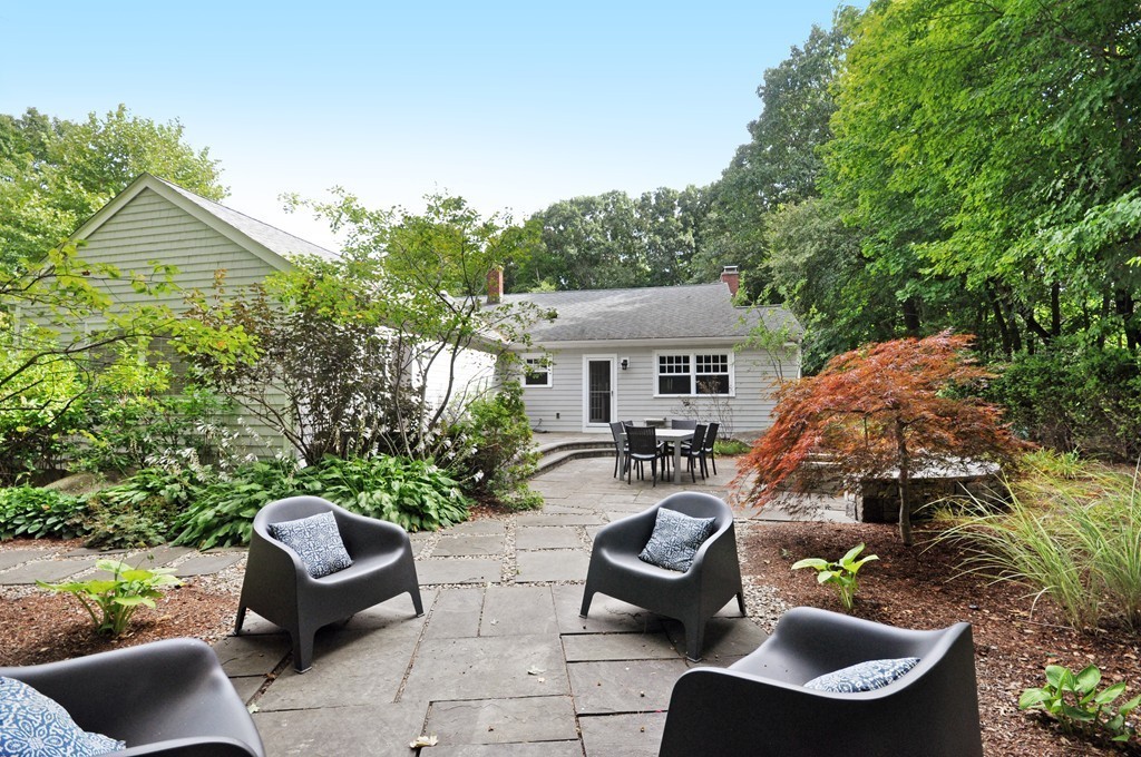 32 Martin Road Concord, MA 01742 - Photo 15 of 17 a view of a patio with couches table and chairs and potted plants