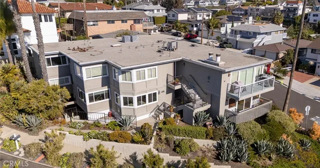 an aerial view of a residential apartment building with a yard