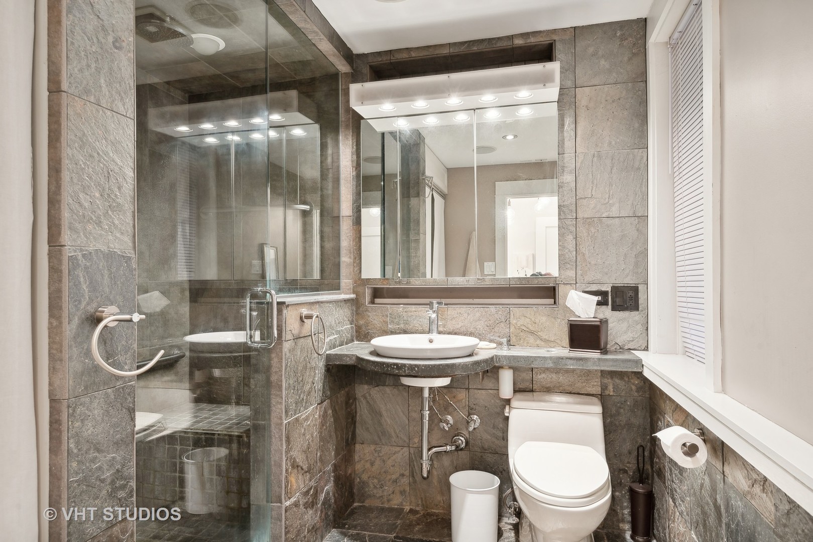 524 Sheridan Road, Unit 2A Evanston, IL 60202 - Photo 16 of 18 a bathroom with a granite countertop sink toilet a mirror and shower