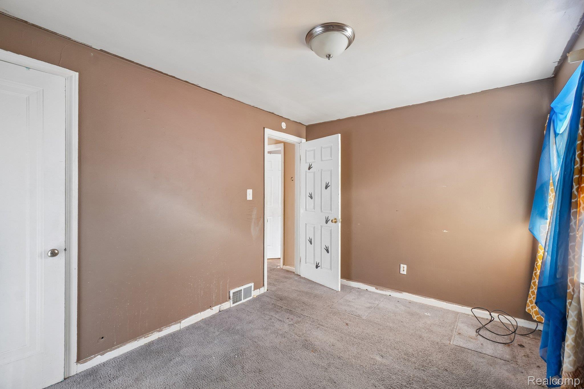 5969 Cadieux Road Detroit, MI 48224 - Photo 18 of 24 Unfurnished bedroom with light colored carpet and baseboards
