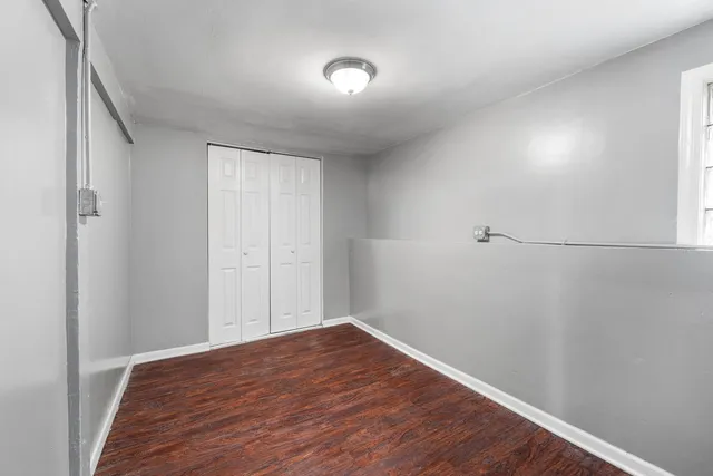 a view of a room with wooden floor