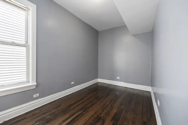 a view of wooden floor in an empty room
