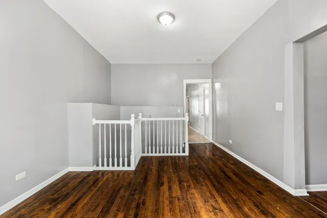 a view of a room with wooden floor