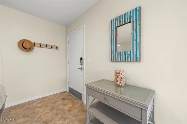 a bedroom with a bed and a refrigerator