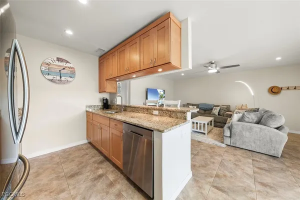 a kitchen with granite countertop a sink and a stove top oven