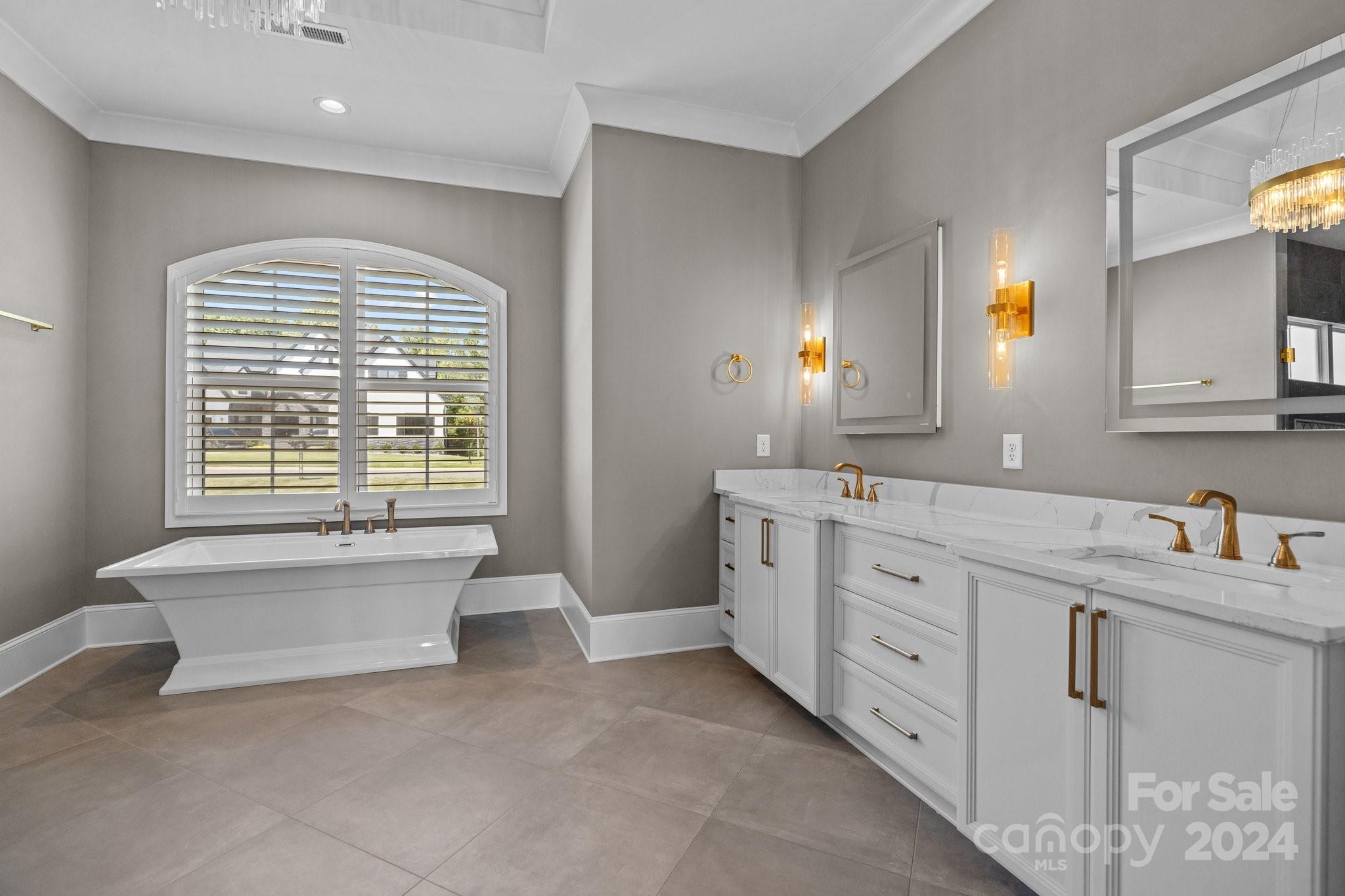 2737 Holbrook Road Fort Mill, SC 29715 - Photo 23 of 46 a spacious bathroom with double vanity a mirror a bathtub and a window
