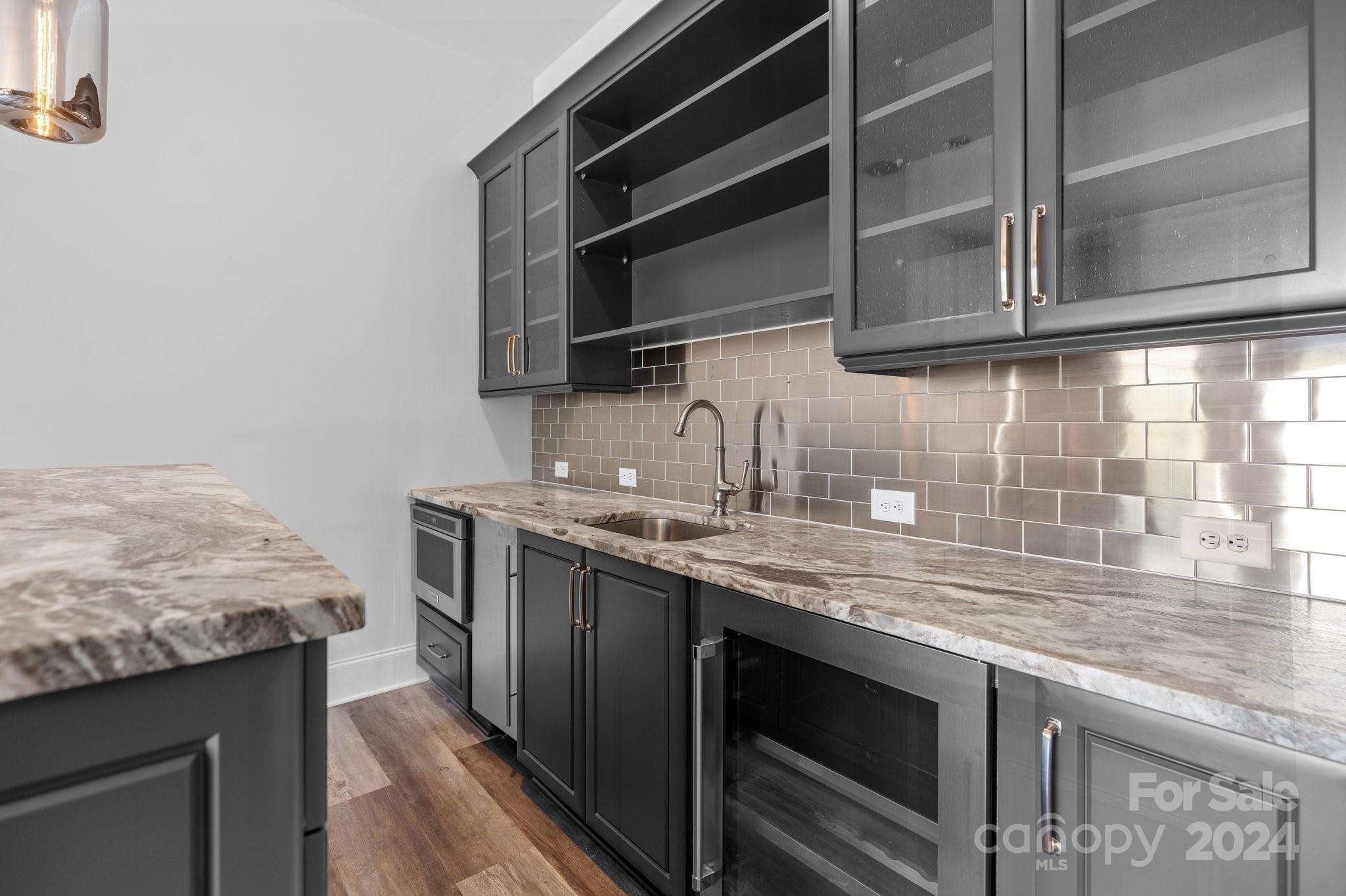 2737 Holbrook Road Fort Mill, SC 29715 - Photo 32 of 46 a kitchen with stainless steel appliances granite countertop a sink stove and microwave