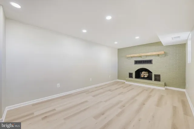 an empty room with fireplace and window