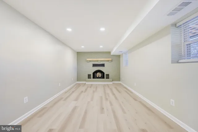 a view of empty room with fireplace
