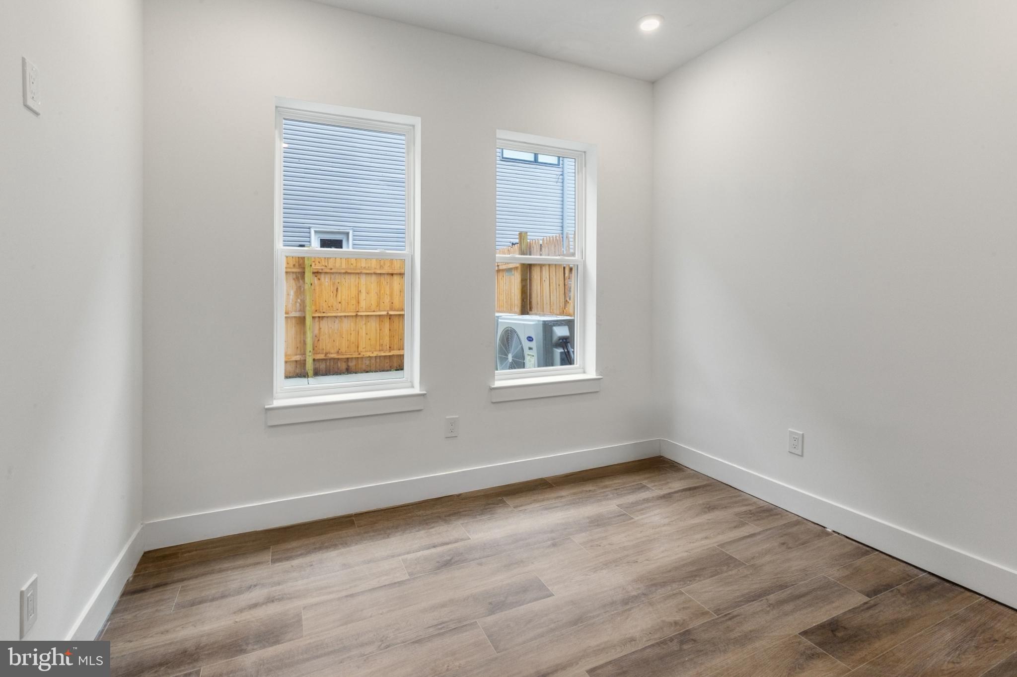 2214 North Front Street, Unit 101 Philadelphia, PA 19133 - Photo 13 of 22 an empty room with wooden floor and windows