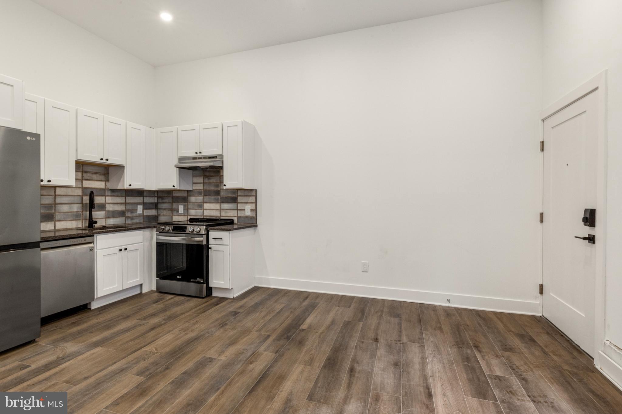 2214 North Front Street, Unit 101 Philadelphia, PA 19133 - Photo 10 of 22 a kitchen with stainless steel appliances a sink and a microwave