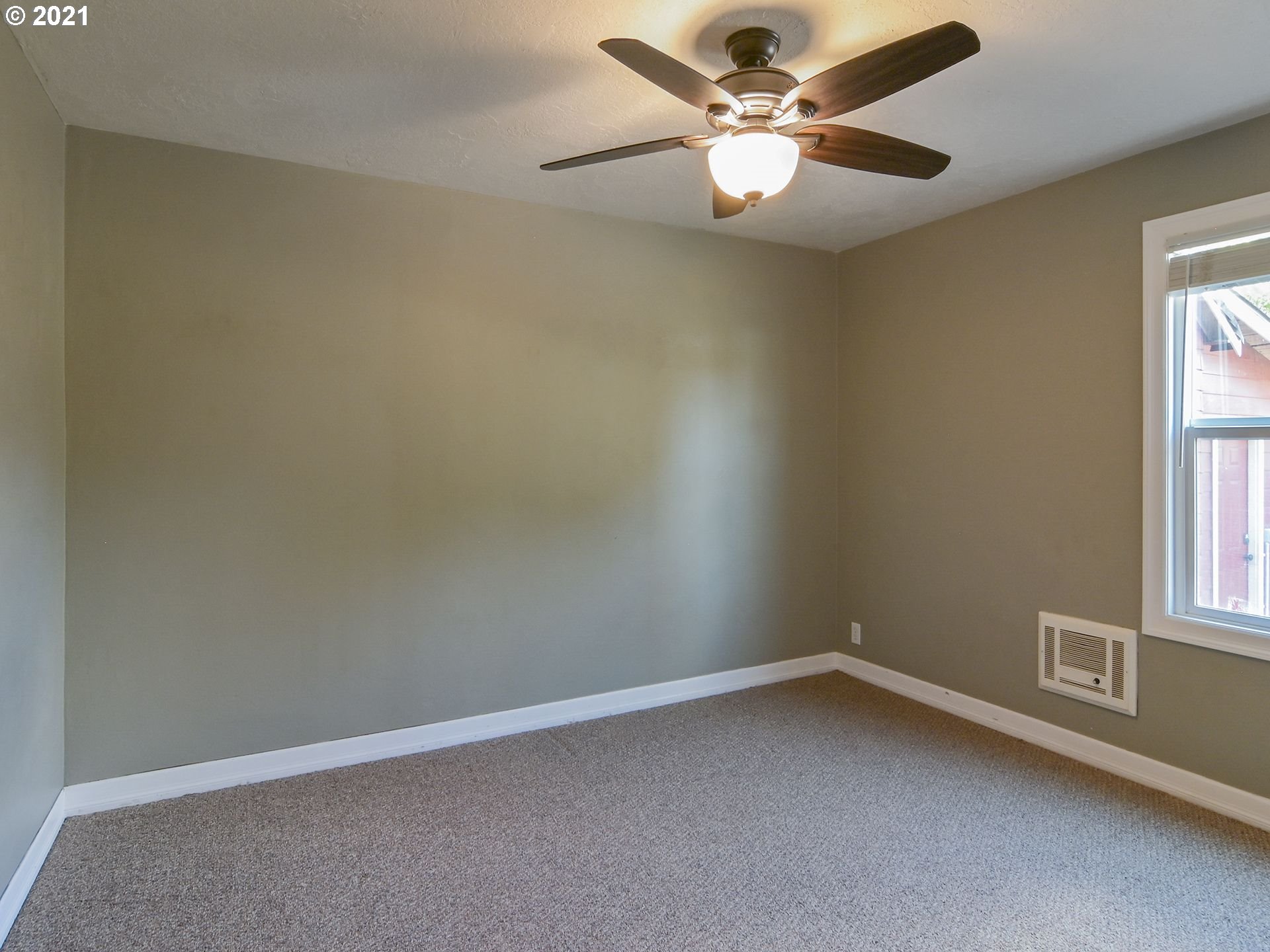 3727 Jasper Road Springfield, OR 97478 - Photo 11 of 32 an empty room with a window and a fan