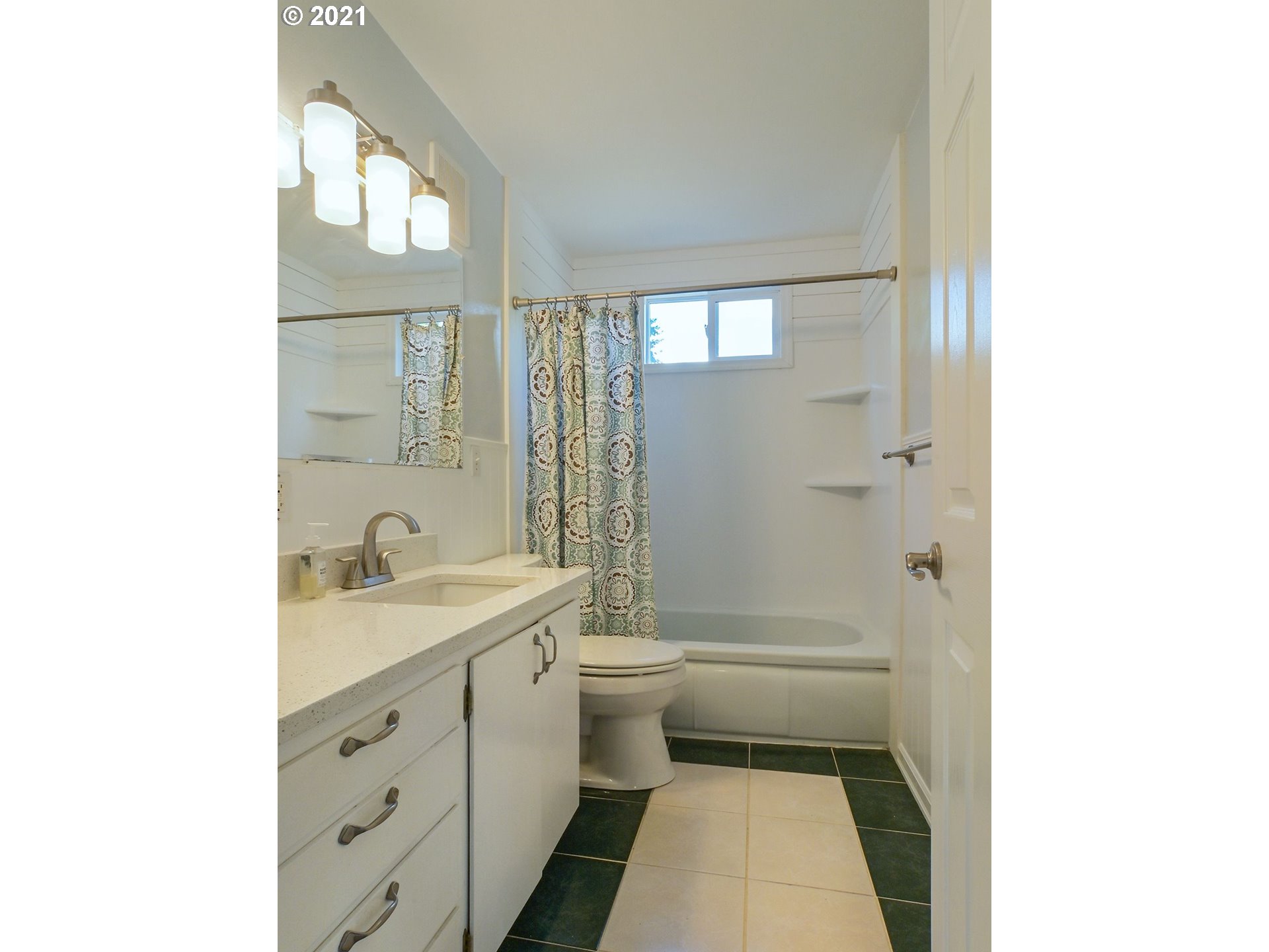 3727 Jasper Road Springfield, OR 97478 - Photo 12 of 32 a bathroom with a granite countertop toilet a sink and a mirror