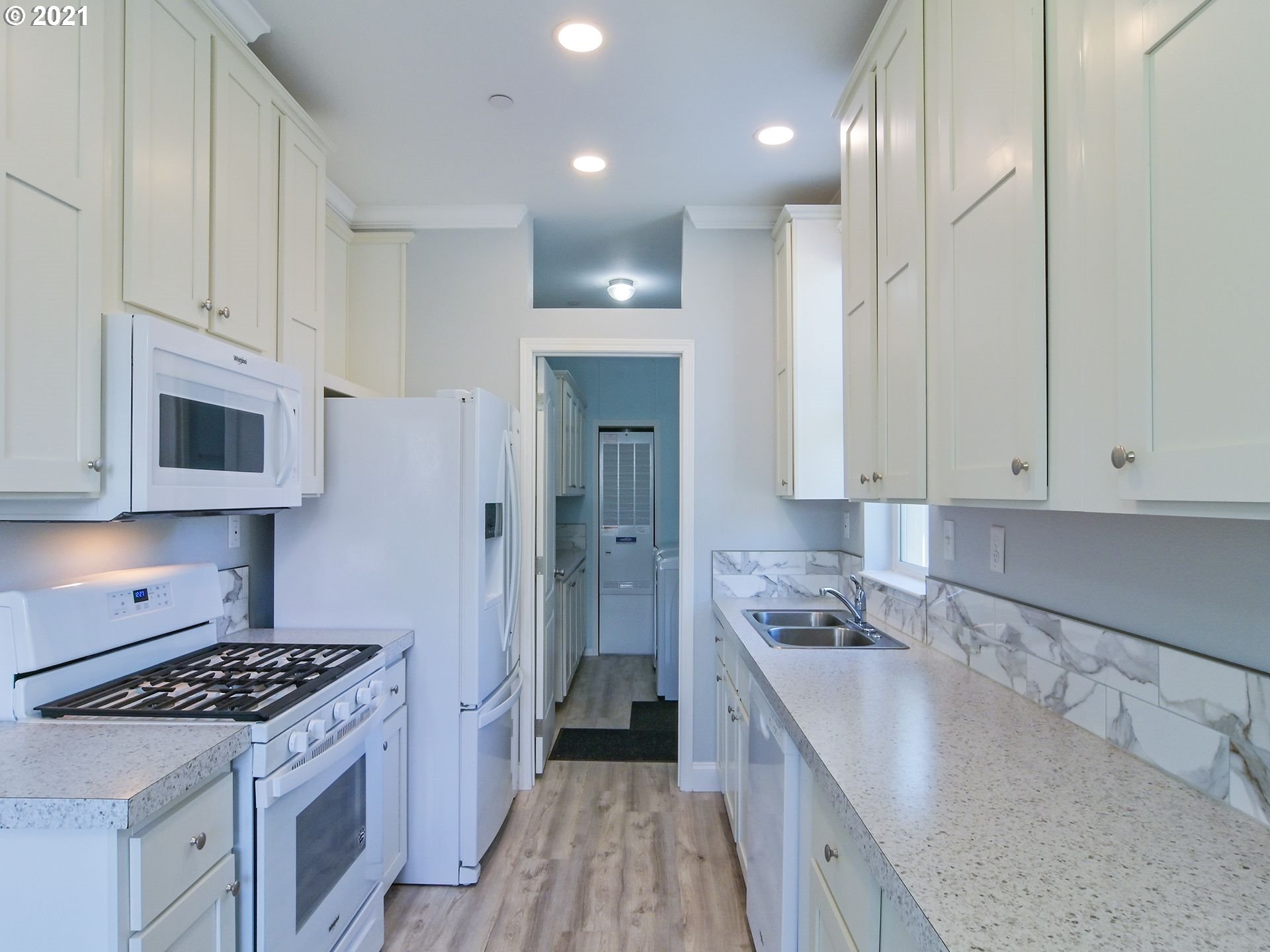 3727 Jasper Road Springfield, OR 97478 - Photo 23 of 32 a kitchen with kitchen island granite countertop a sink a stove and refrigerator