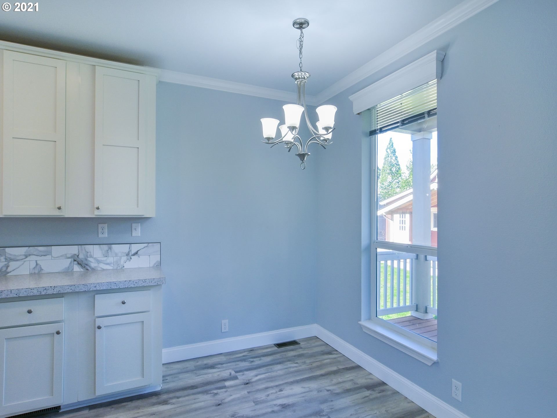 3727 Jasper Road Springfield, OR 97478 - Photo 24 of 32 a view of a kitchen cabinets a chandelier and wooden floor