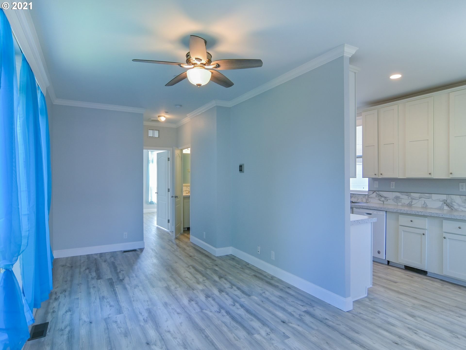 3727 Jasper Road Springfield, OR 97478 - Photo 25 of 32 a view of an empty room with wooden floor and a ceiling fan