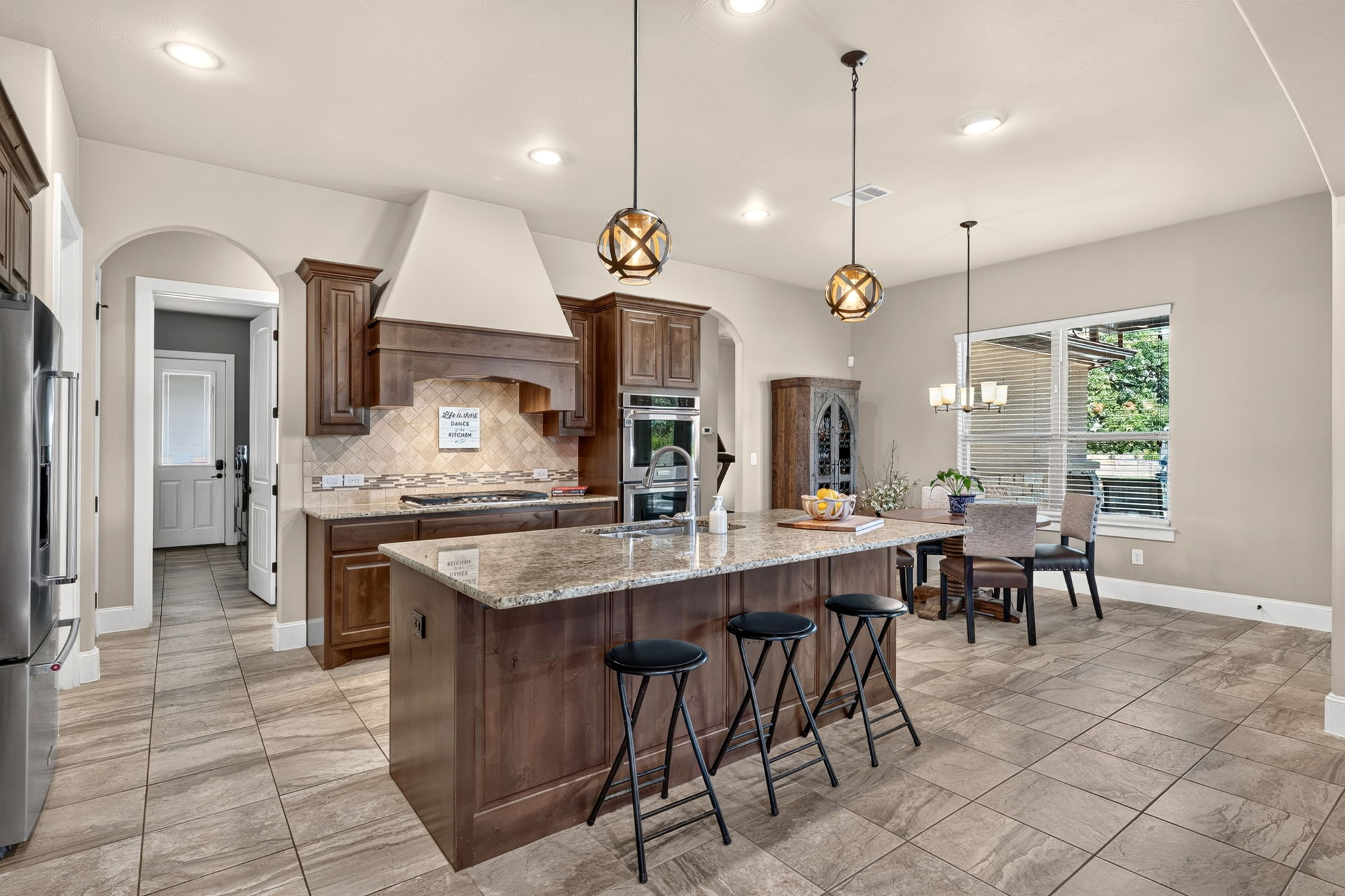 105 Coopers Hill Road Georgetown, TX 78633 - Photo 15 of 40 a large kitchen with kitchen island a table and chairs in it