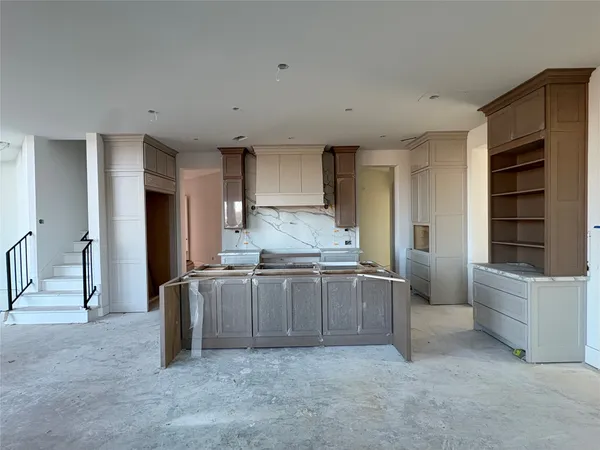 a kitchen with granite countertop a refrigerator and a stove