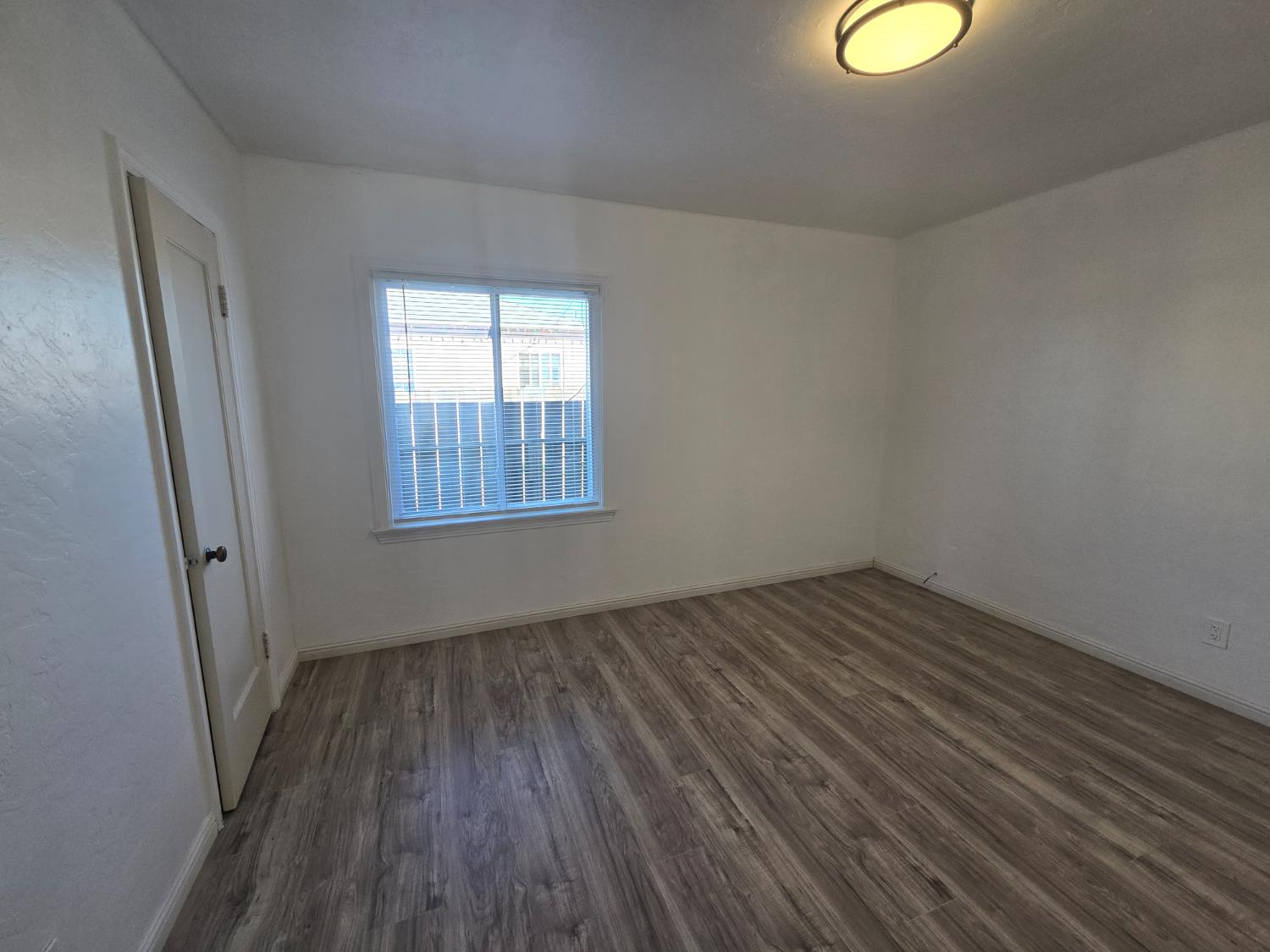 320 North Sanborn Road Salinas, CA 93905 - Photo 24 of 26 an empty room with wooden floor and windows