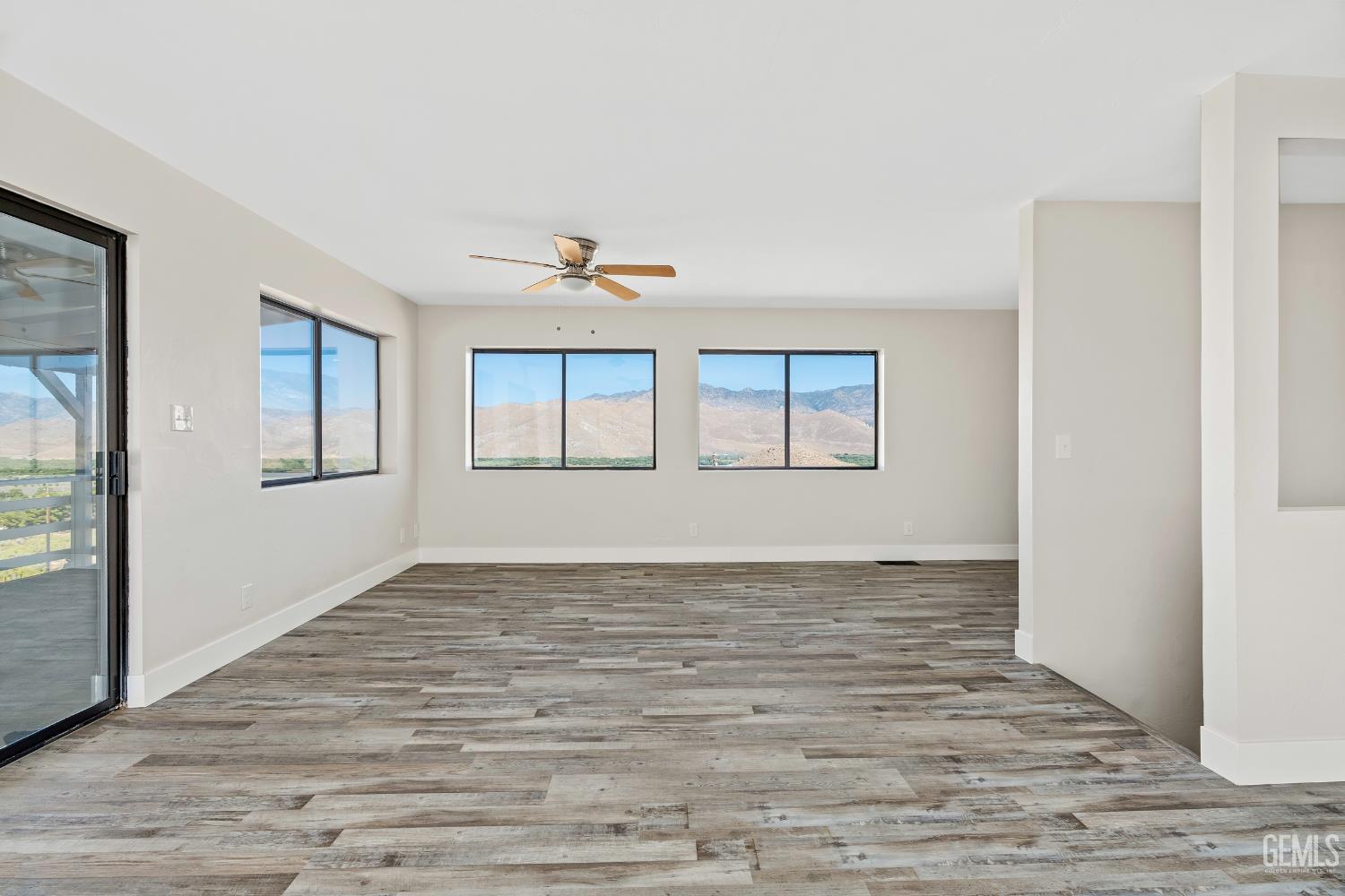 Undisclosed Address Weldon, CA 93283 - Photo 16 of 48 a view of empty room with wooden floor and fan