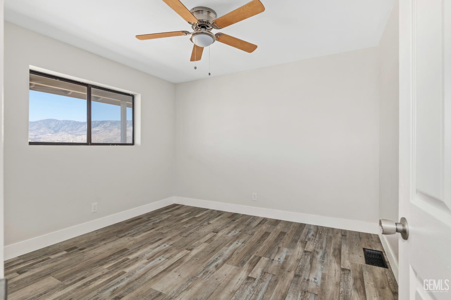 Undisclosed Address Weldon, CA 93283 - Photo 22 of 48 an empty room with a window and wooden floor