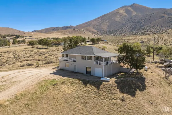 a view of a house with a mountain yard