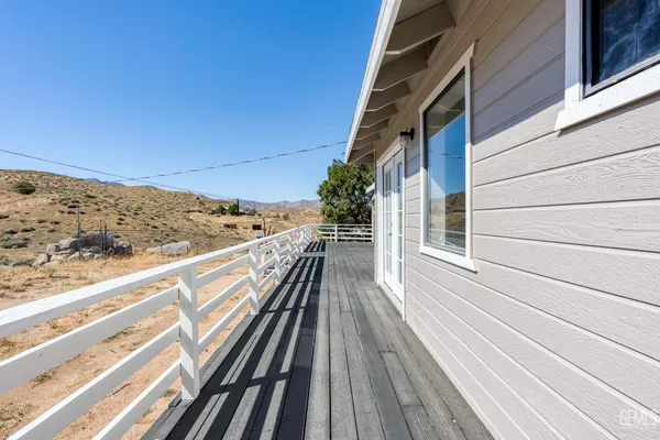 a view of balcony with wooden floor and fence