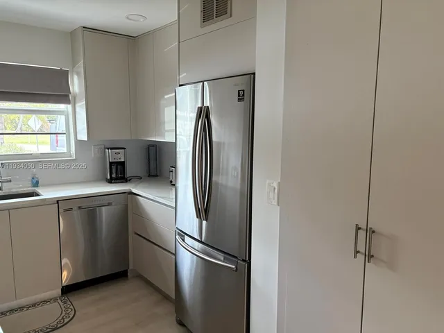 a kitchen with stainless steel appliances a refrigerator and a sink