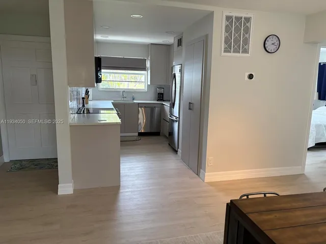 a view of a kitchen with a sink dishwasher and a refrigerator