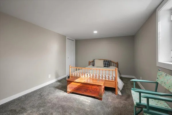a bedroom with a bed and a chair