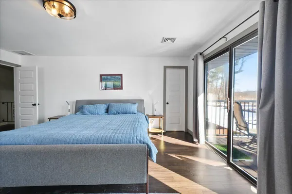 a bedroom with a large bed and a large window
