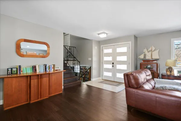 a living room with furniture and a floor to ceiling window