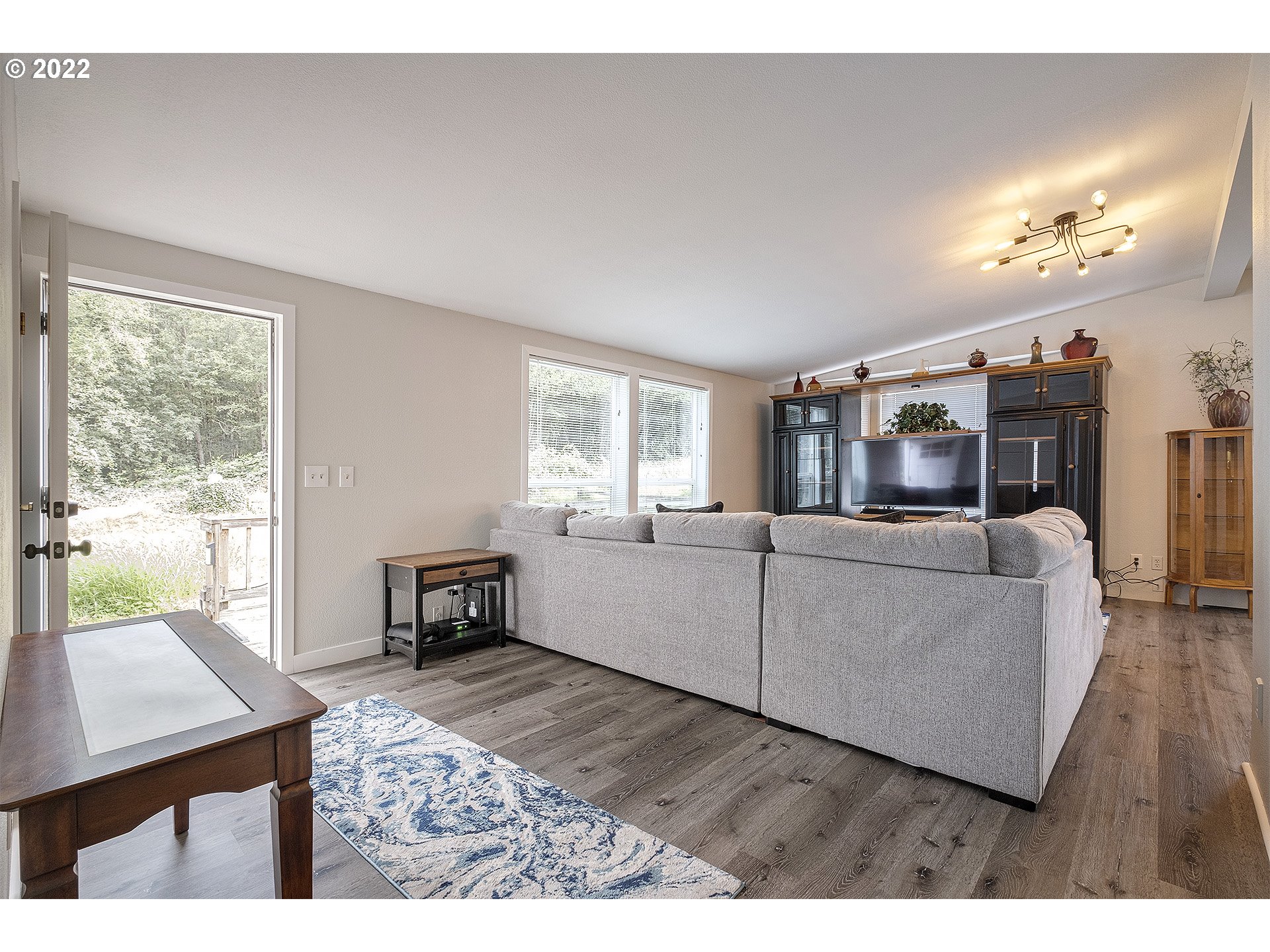 31934 Highland Road Rainier, OR 97048 - Photo 2 of 27 a living room with furniture a dining table a large window and wooden floor