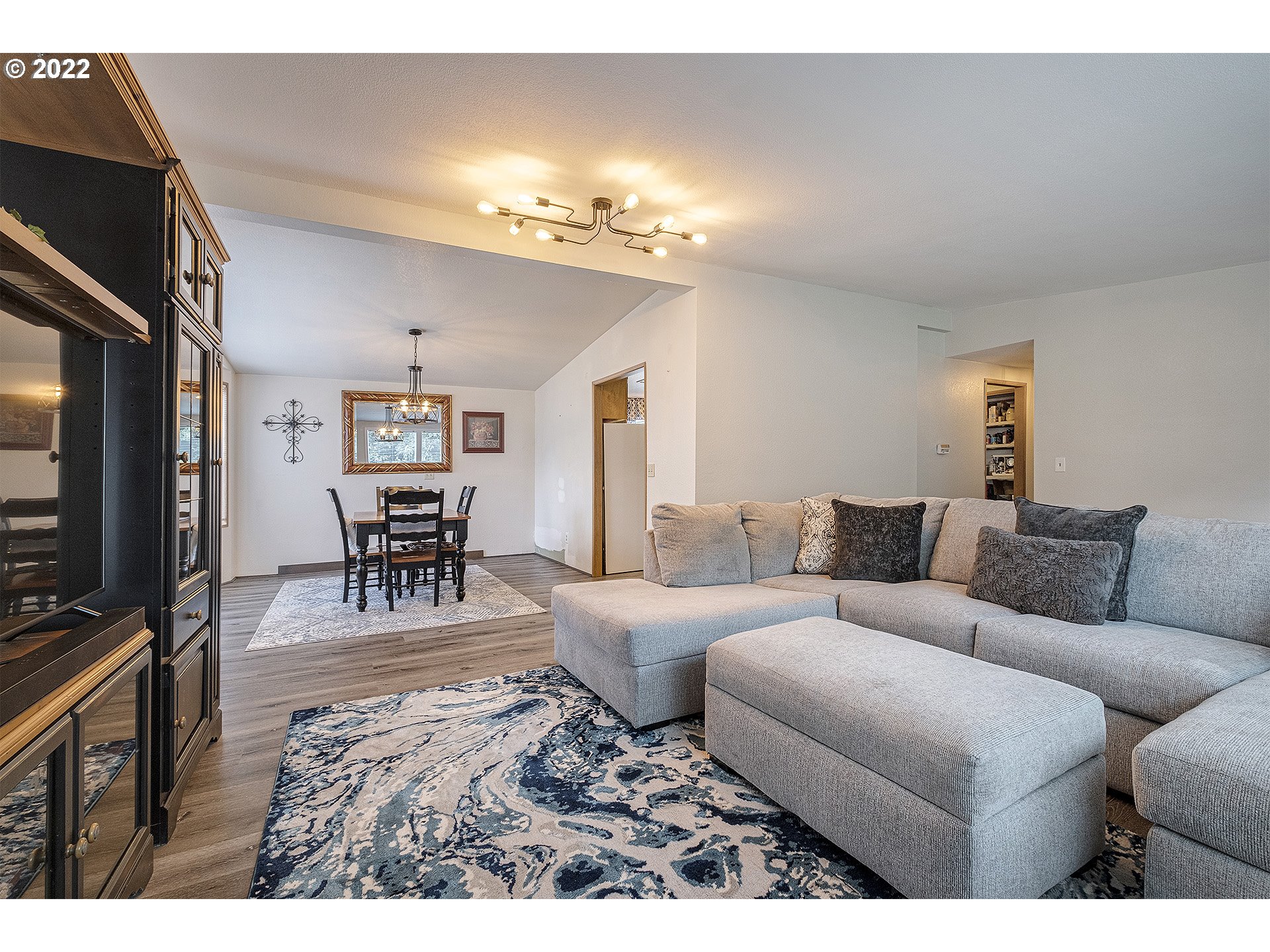 31934 Highland Road Rainier, OR 97048 - Photo 5 of 27 a living room with furniture a chandelier and a flat screen tv