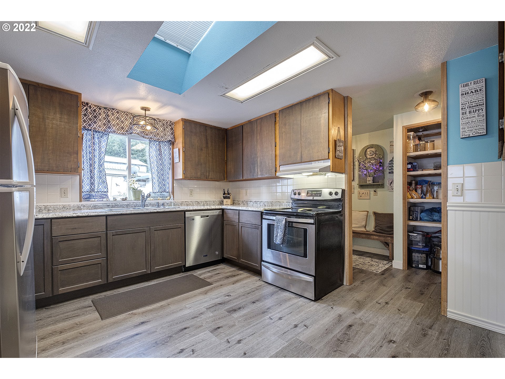 31934 Highland Road Rainier, OR 97048 - Photo 8 of 27 a kitchen with refrigerator cabinets and large window