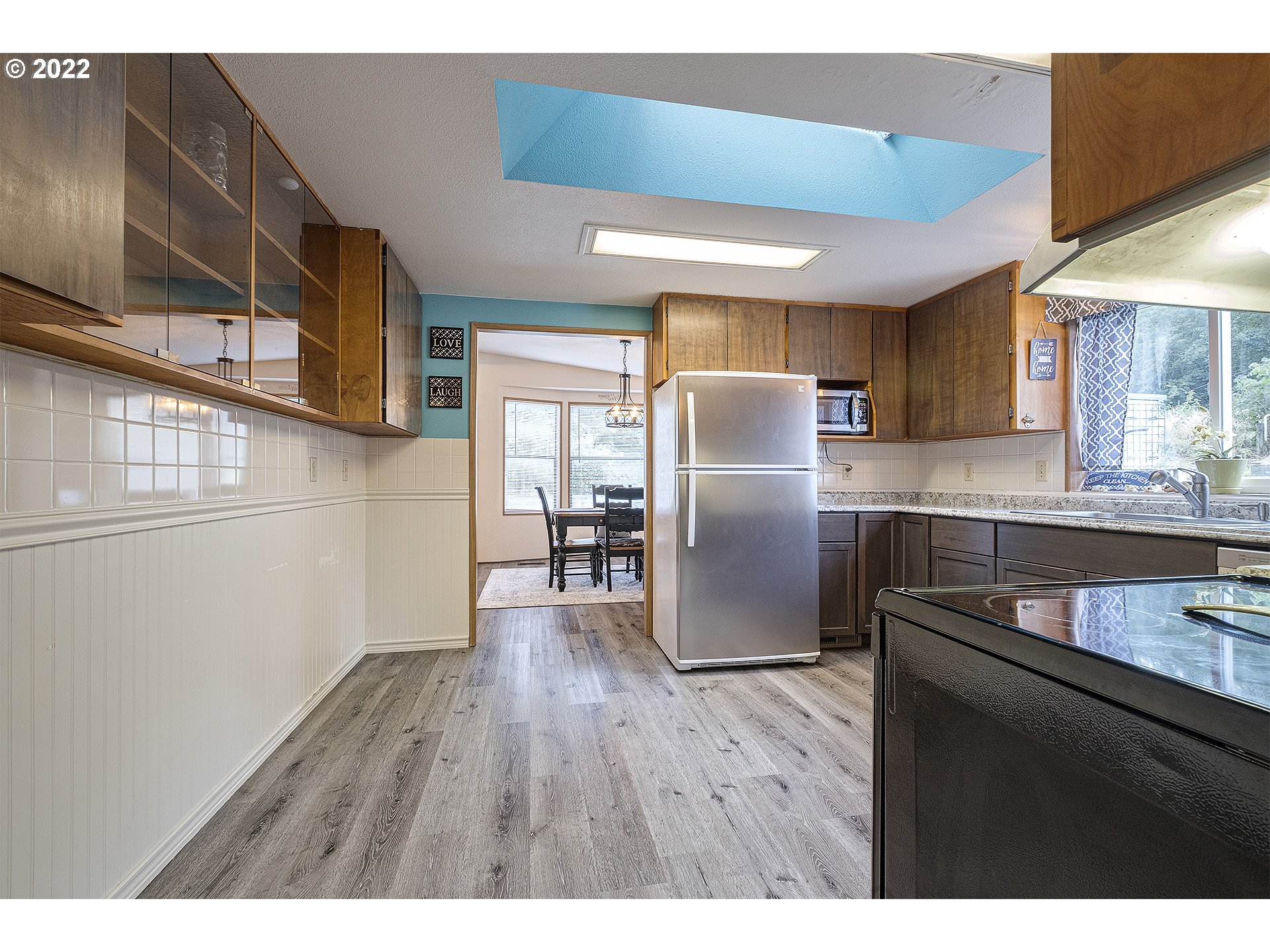 31934 Highland Road Rainier, OR 97048 - Photo 9 of 27 a kitchen with stainless steel appliances granite countertop a refrigerator a sink dishwasher a stove with wooden floor