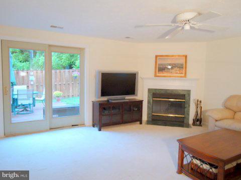 13928 Winding Ridge Lane Centreville, VA 20121 - Photo 2 of 29 a living room with furniture and a flat screen tv