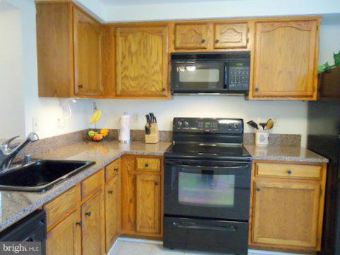 13928 Winding Ridge Lane Centreville, VA 20121 - Photo 11 of 29 a kitchen with stainless steel appliances granite countertop a sink and a microwave