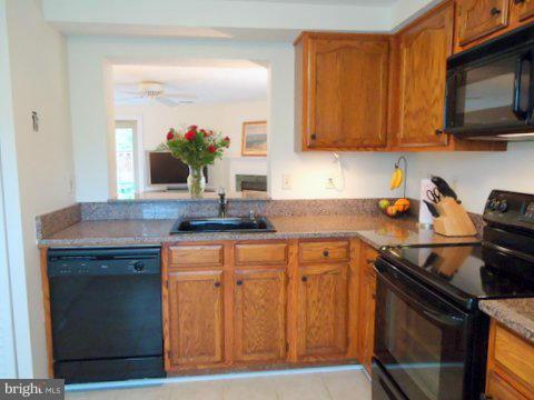 13928 Winding Ridge Lane Centreville, VA 20121 - Photo 12 of 29 a kitchen with stainless steel appliances granite countertop a stove a sink and a microwave