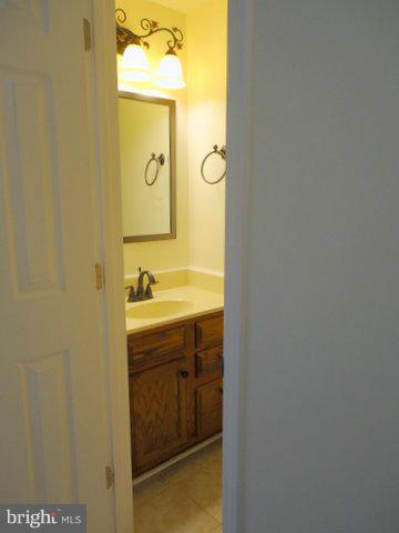 13928 Winding Ridge Lane Centreville, VA 20121 - Photo 14 of 29 a bathroom with a sink and mirror