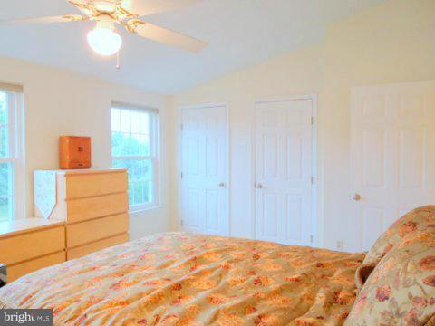 13928 Winding Ridge Lane Centreville, VA 20121 - Photo 17 of 29 a bedroom with a bed and a chandelier