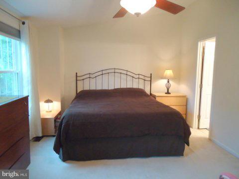 13928 Winding Ridge Lane Centreville, VA 20121 - Photo 20 of 29 a bedroom with a bed and a flat tv screen